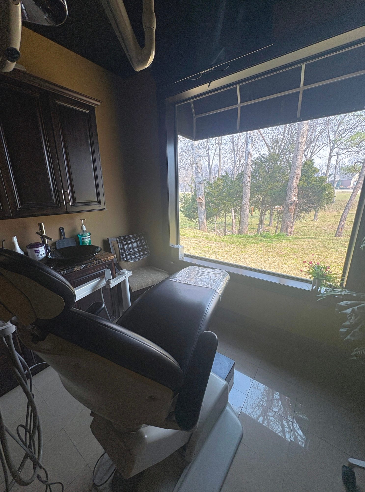 Treatment room with a window view of the trees
